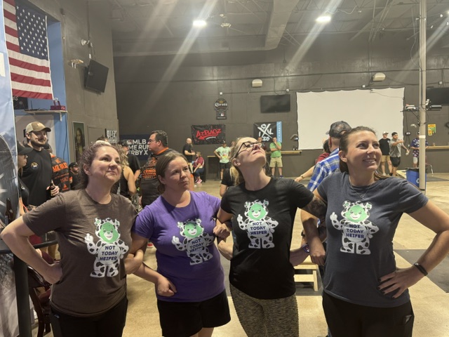 Team in matching shirts striking heroic poses