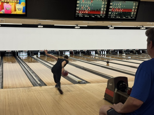 Bowler in full follow-through delivering a shot