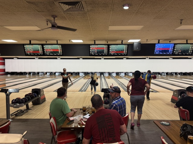 Wide view of tournament crowd across busy lanes